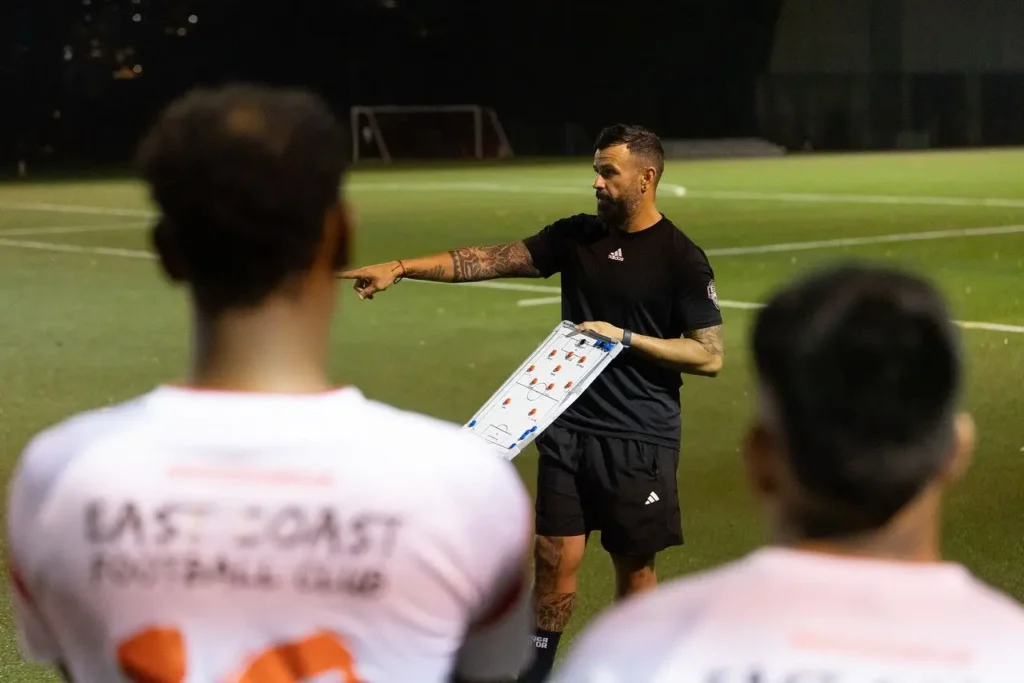 occer coach giving tactical instructions during player development training at Next Play Soccer