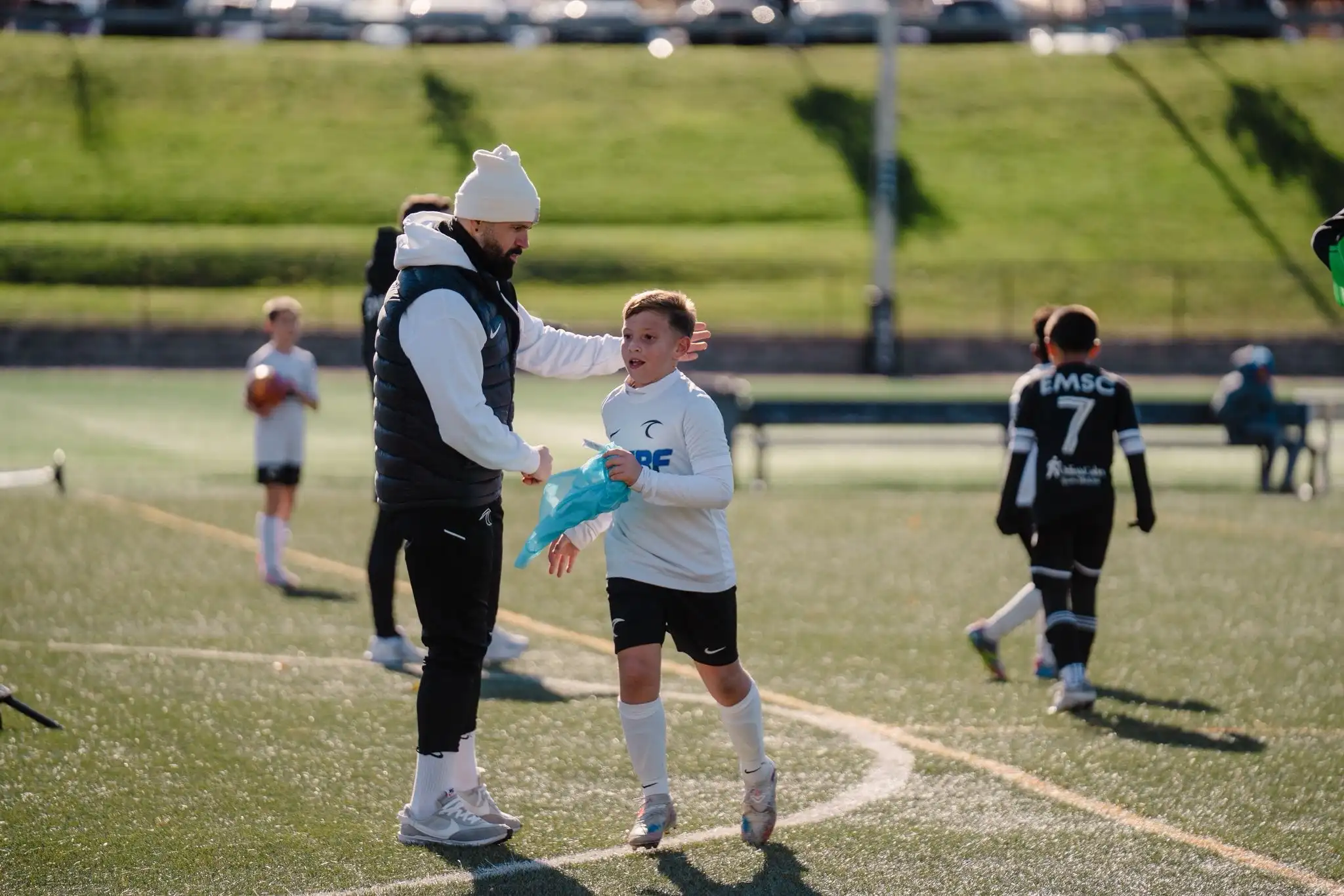 Next Play Soccer coach working with a youth player during training
